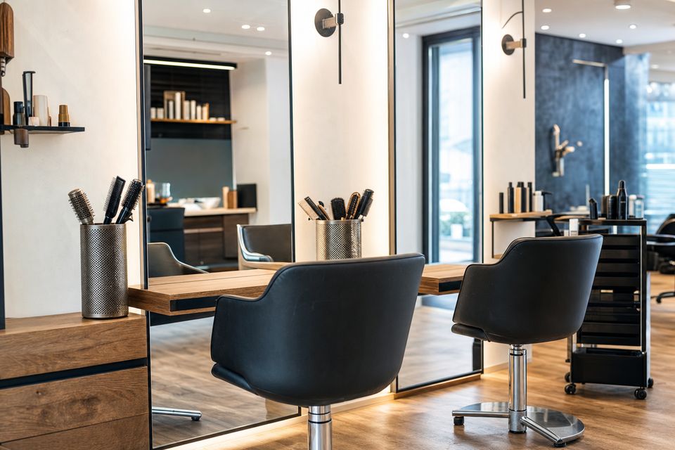 the room seen from a different angle, detail of the working area, chairs and mirrors, no people